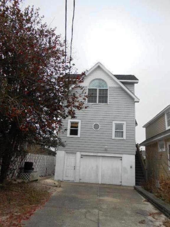 a gray and white house with a garage at Beach Haven Single Family Oceanside Beach Badges Wifi in Beach Haven