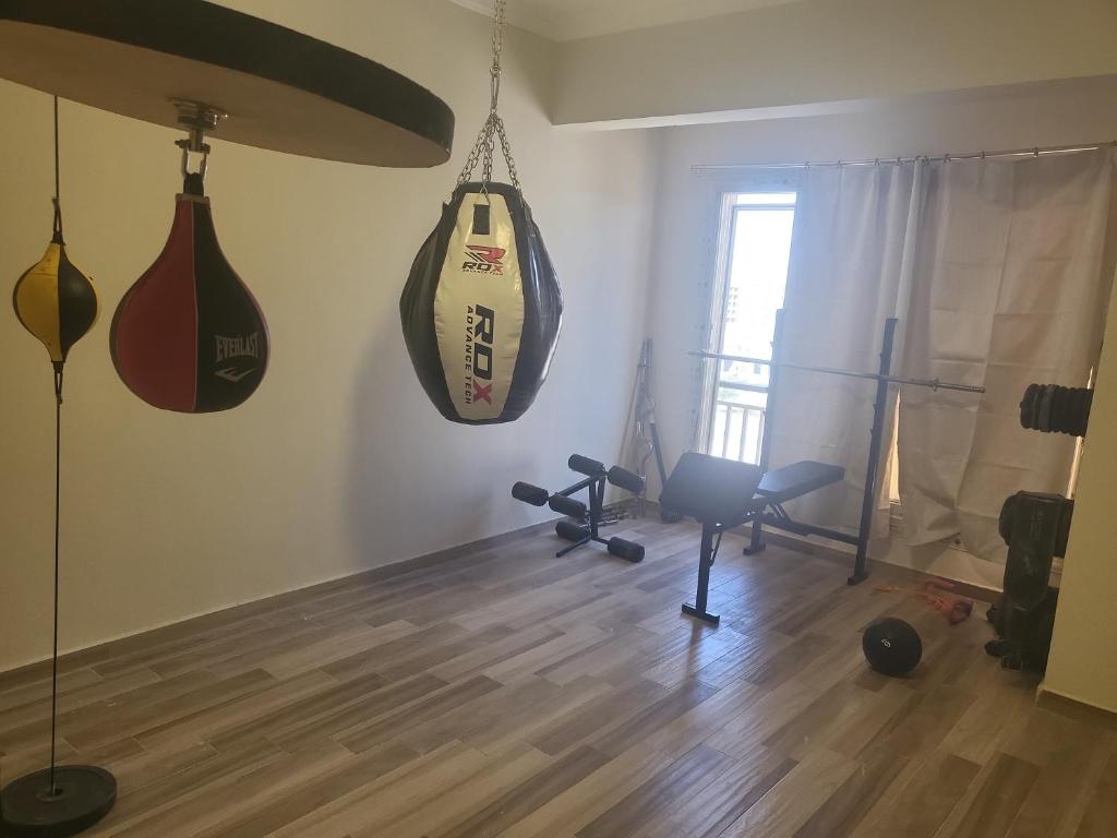 a living room with two hanging bags on the wall at شقه إيجار wesal in Madīnat ash Shurūq