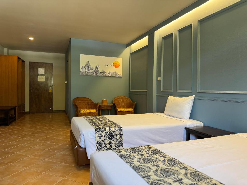 Postel nebo postele na pokoji v ubytování Sun Hotel
