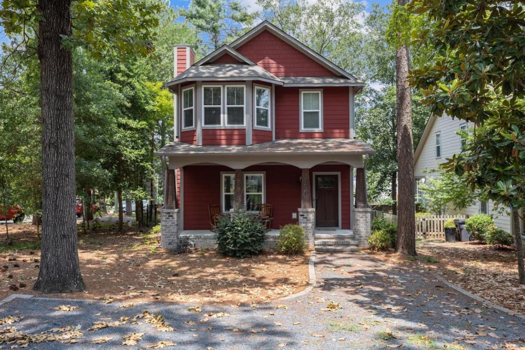 a red house with trees in front of it at Hunter House Southern Pines in Southern Pines