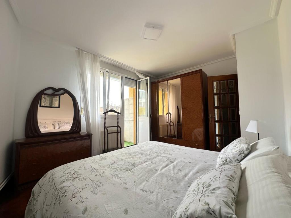 a bedroom with a large bed and a mirror at Monuca - 3803 in Santoña