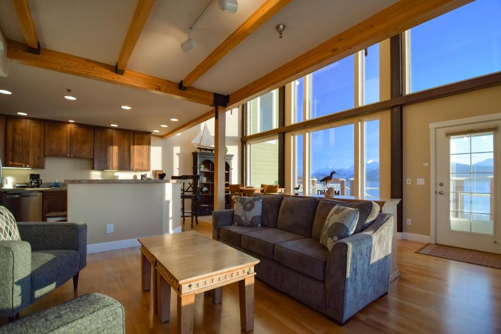 a living room with a couch and a table at Lakeshore Lodging Lodge 722 in Homer