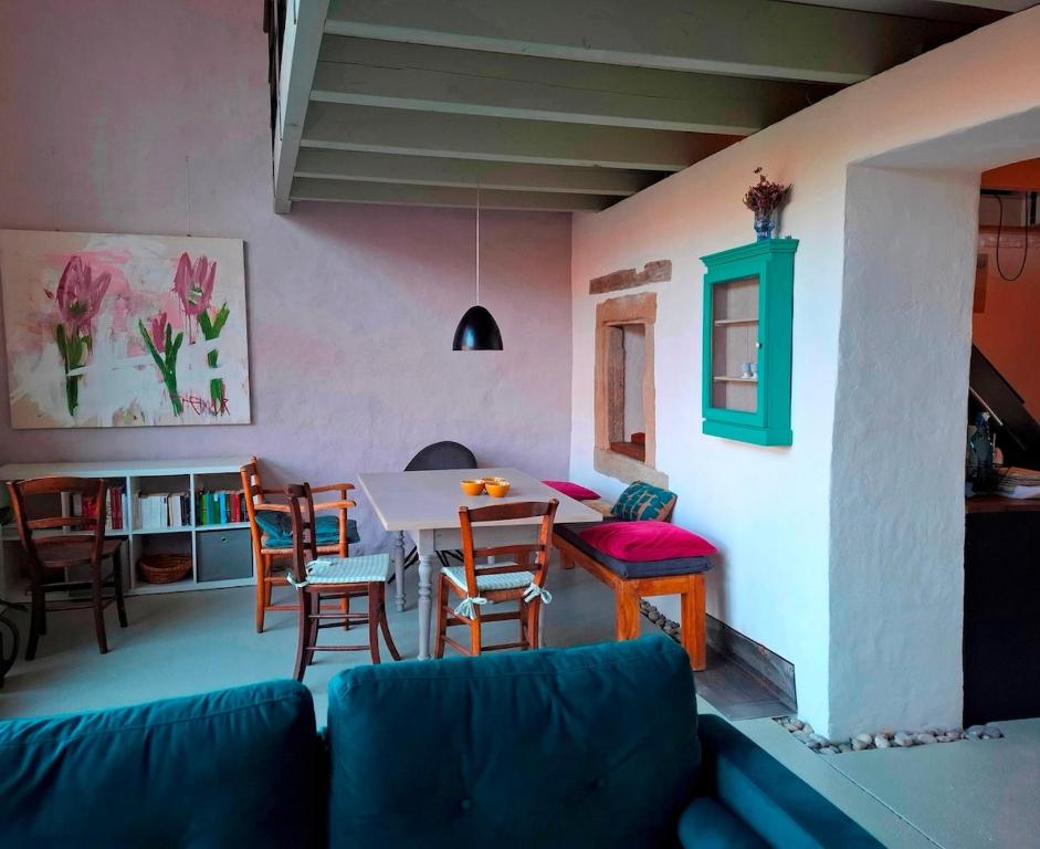 a living room with a couch and a table and chairs at Atelierhaus in Rehborn