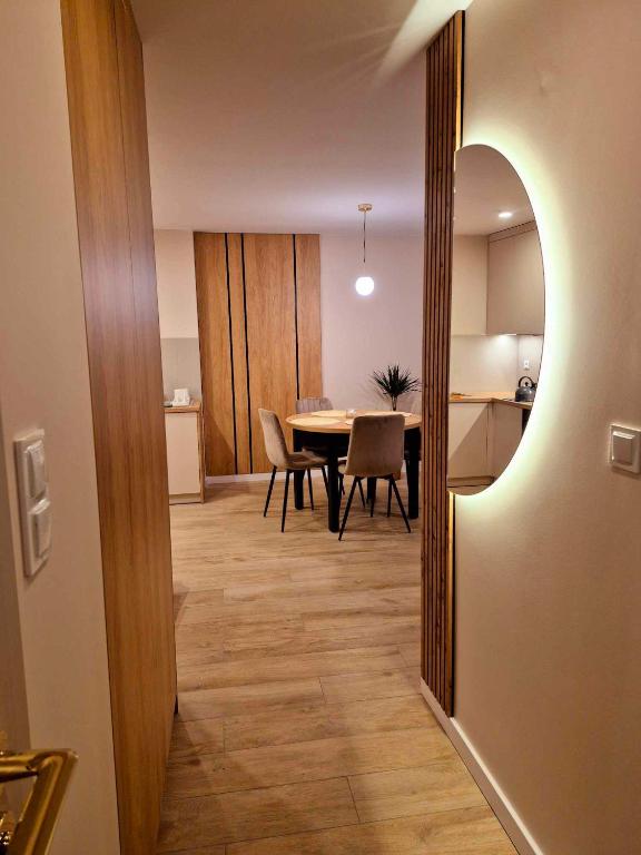 a dining room and kitchen with a table and chairs at Apartament Balladyny in Lublin