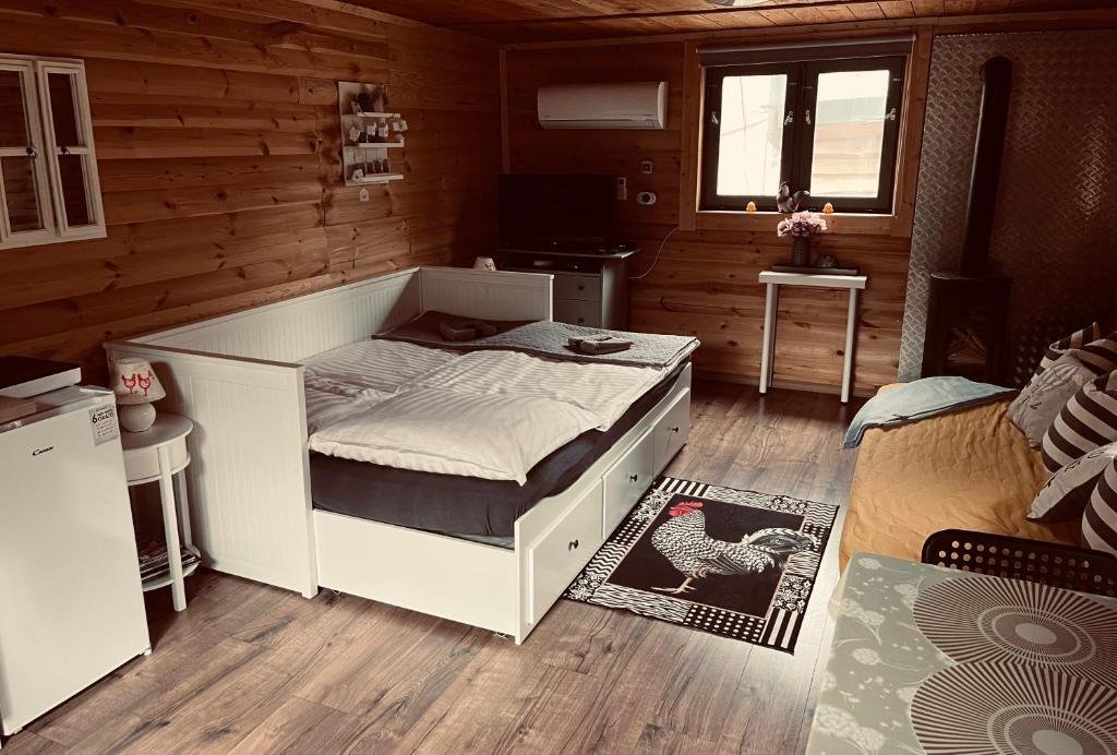 a bedroom with a bed in a wooden room at Pipi Vityilló in Füzérradvány