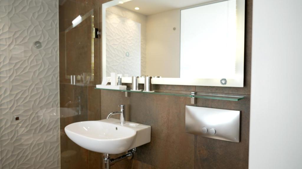 a bathroom with a sink and a mirror at Hotel Arctic in Ilulissat