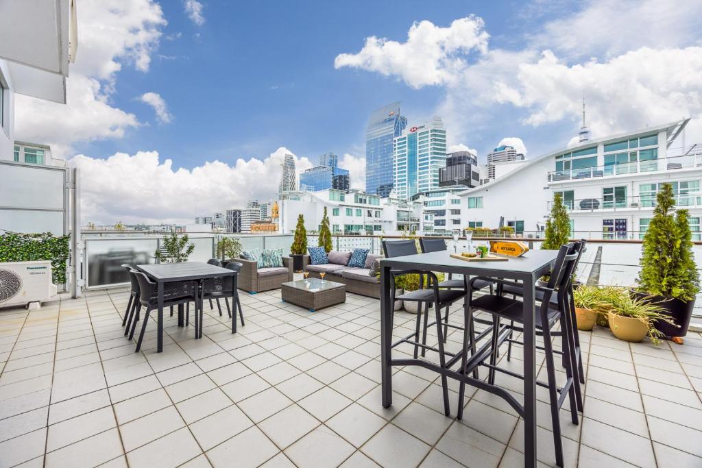 a balcony with a table and chairs on a building at Princes Wharf with HUGE deck!! in Auckland