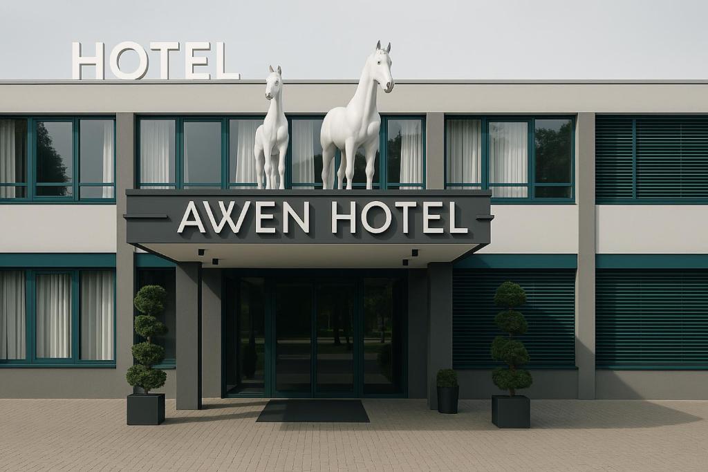 a hotel with two horses on the top of it at Awen Hotel Vechta in Vechta