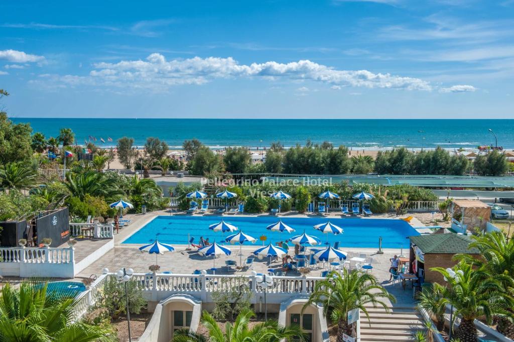 an aerial view of a resort with a pool and the ocean at Pellegrino Palace Hotel in Vieste