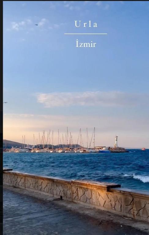 a view of the ocean with a harbor and a lighthouse at Adakonak Urla in Urla