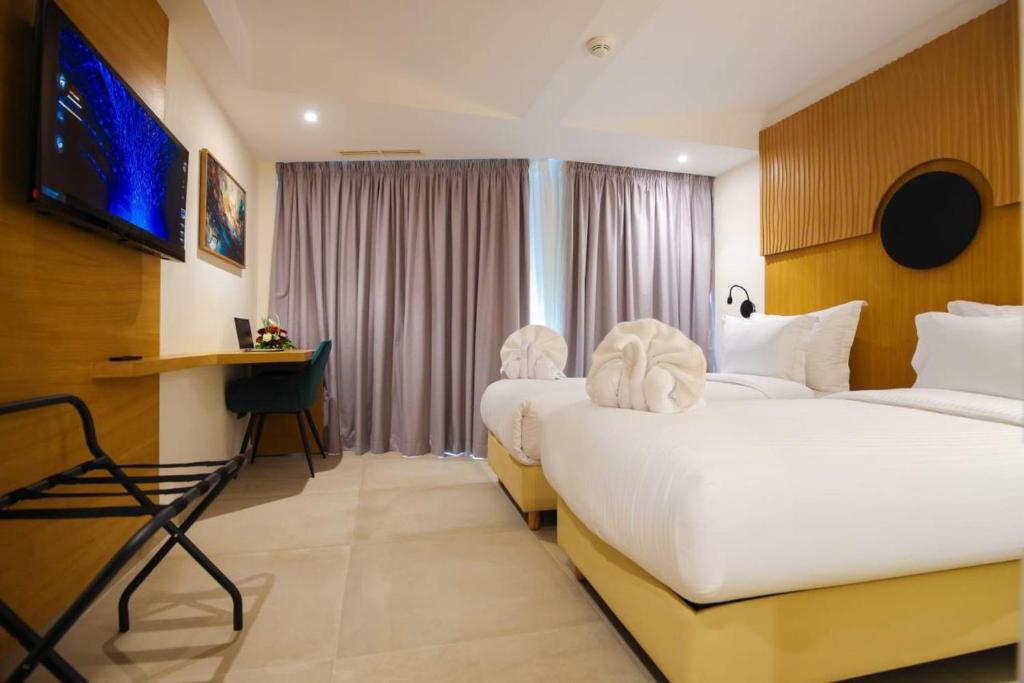 Postel nebo postele na pokoji v ubytování FAHO Hôtel