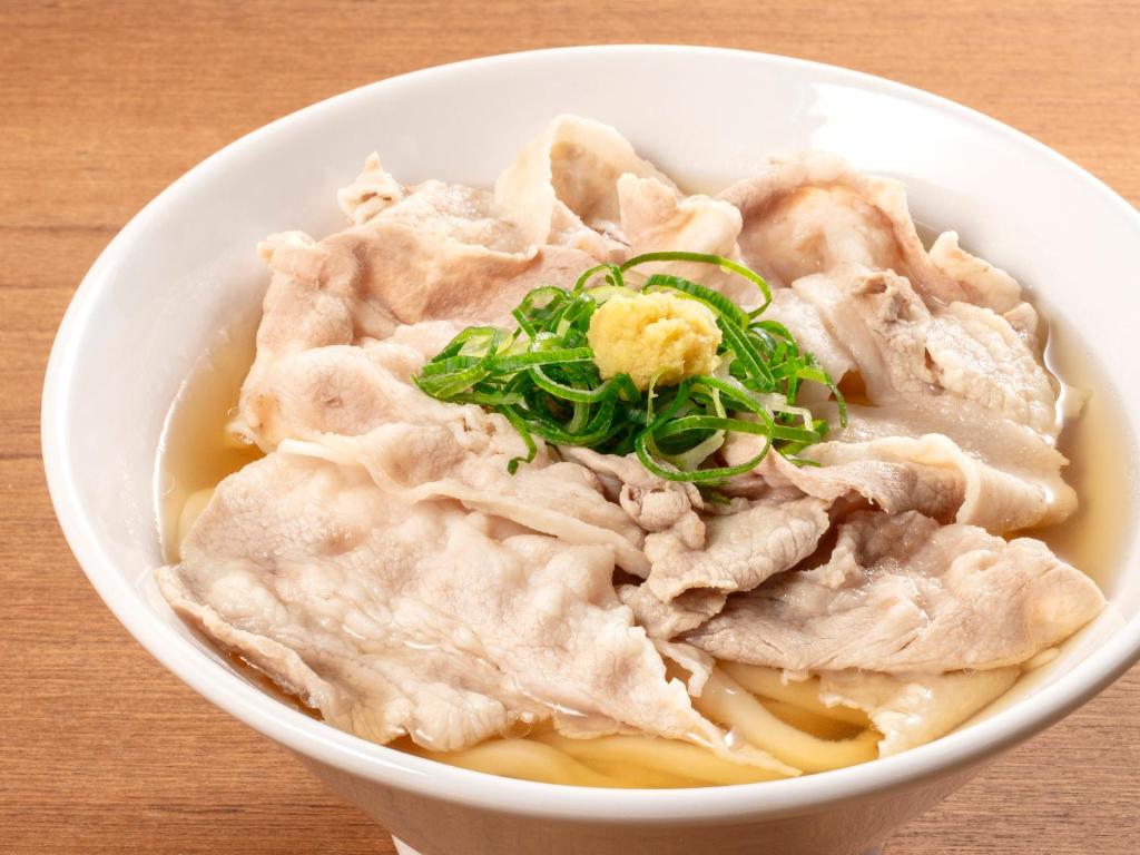 a bowl of food with meat and green onions at APA Hotel Shibuya Dogenzakaue in Tokyo