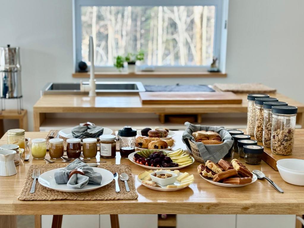 a table with a bunch of food on it at Le Camp Caché Shefford in Shefford