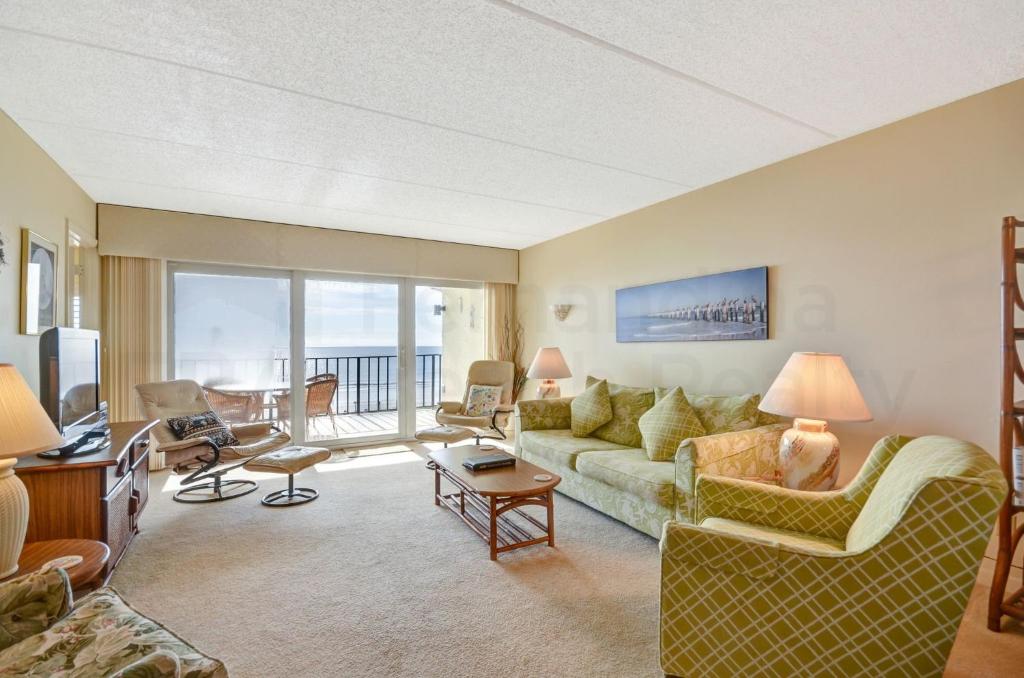 a living room with a couch and a table at Oceanview Amelia South Condo in Fernandina Beach