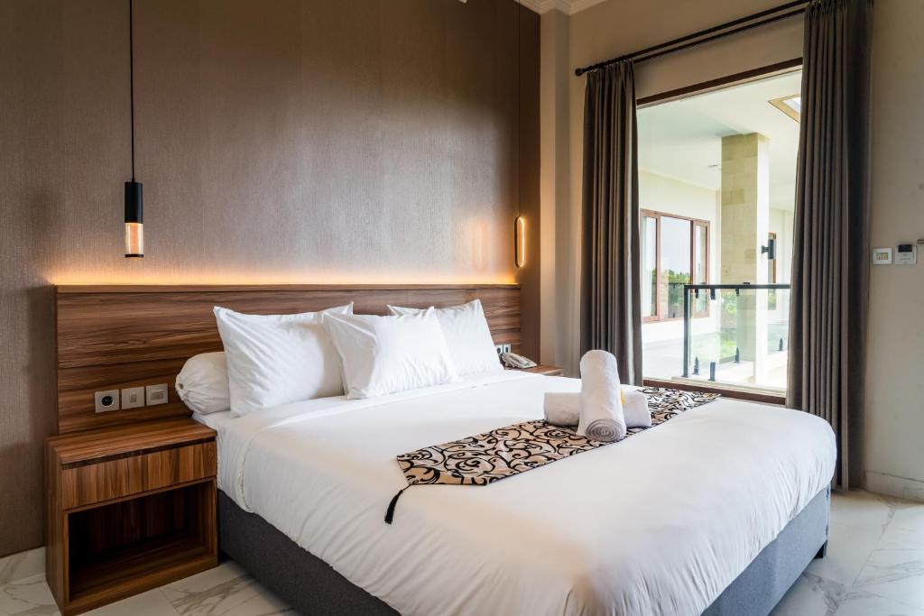 Postel nebo postele na pokoji v ubytování Ayers Hotel&Resto