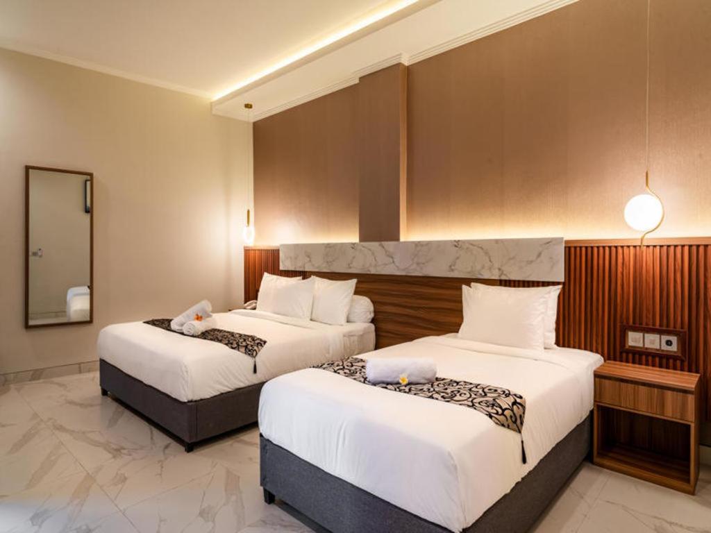 Postel nebo postele na pokoji v ubytování Ayers Hotel&Resto