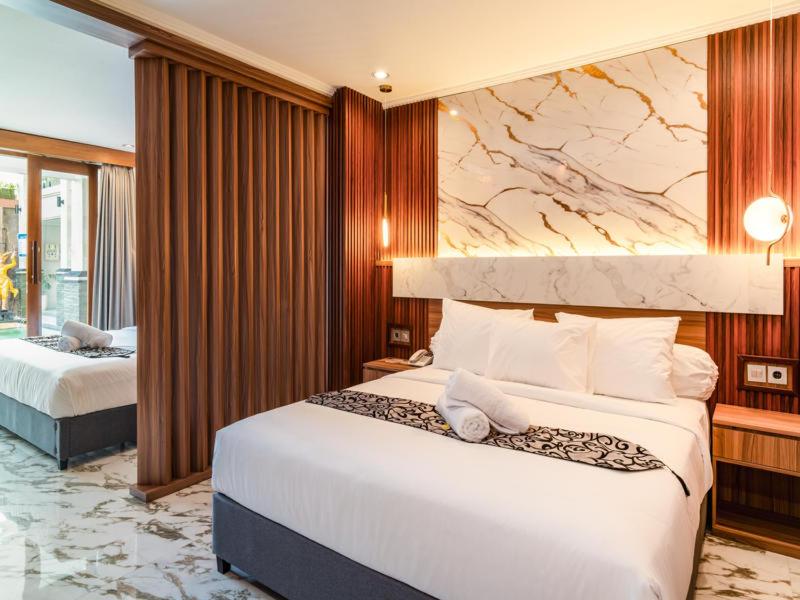 Postel nebo postele na pokoji v ubytování Ayers Hotel&Resto