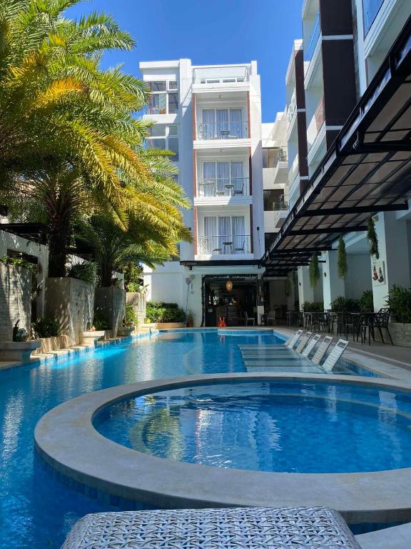 a large swimming pool in front of a building at Boracay Haven Suites in Boracay