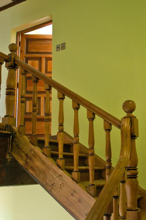 a wooden staircase with wooden railings in a house at Aji Hostel in Santiago