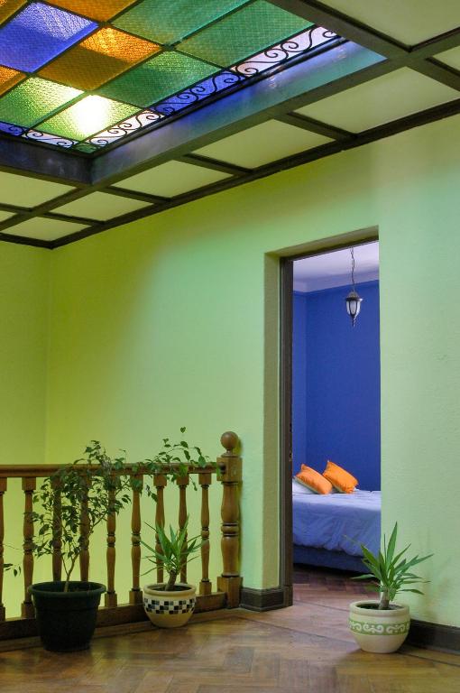 a room with a bed and potted plants in it at Aji Hostel in Santiago