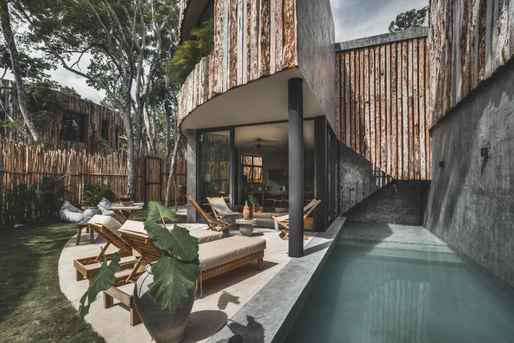 an external view of a house with a swimming pool at Jungle Luxury Villa Pvt Pool 100mbs AC Concierge D9 in Tulum