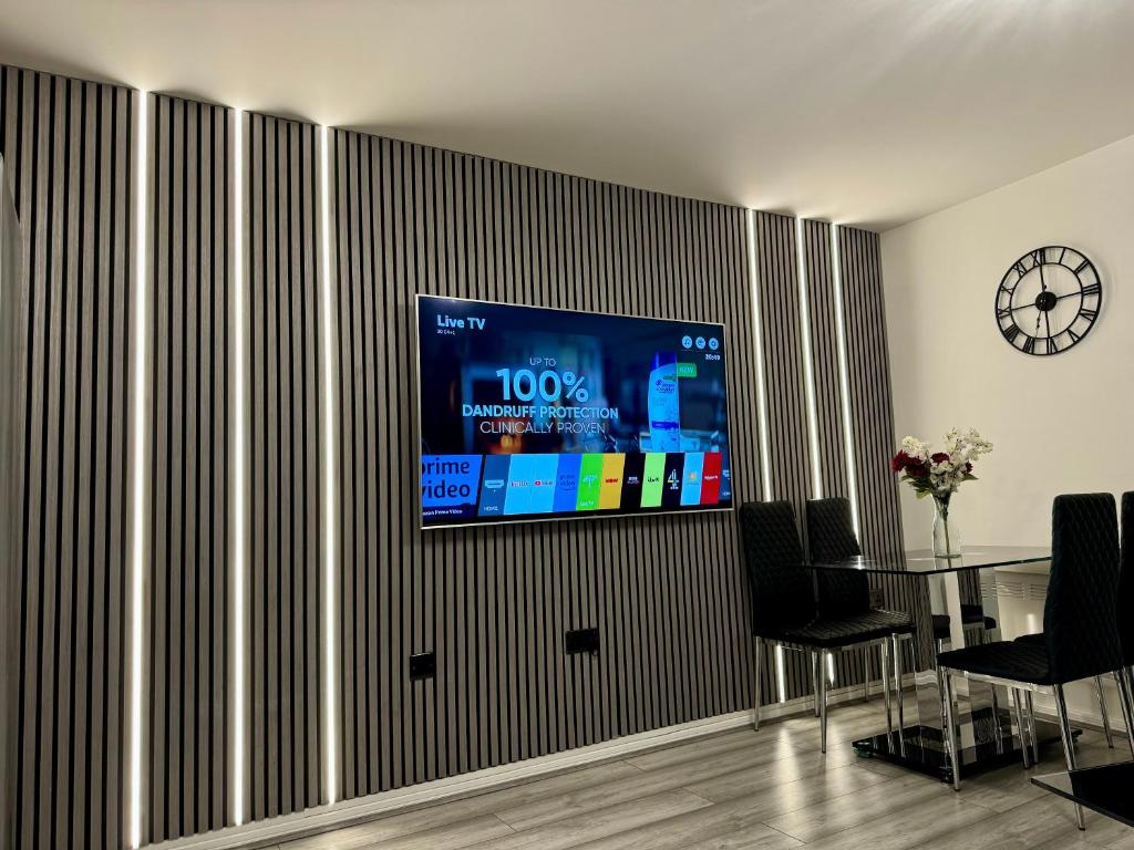 a flat screen tv hanging on a wall at City View Apartments in Manchester