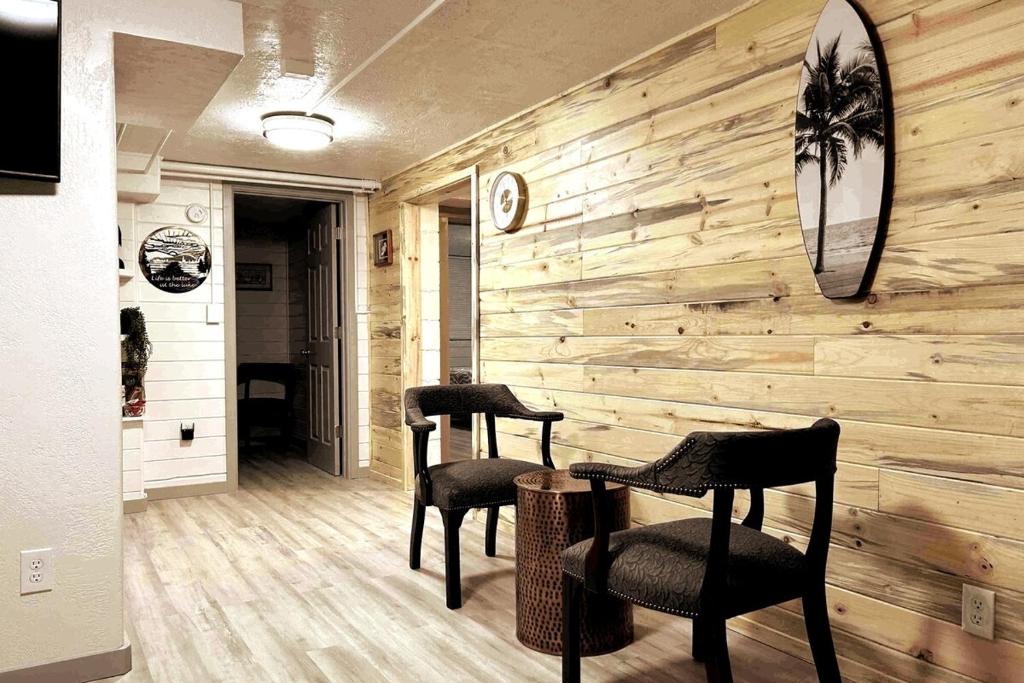 a room with two chairs and a wooden wall at Ruby's Lakefront Lower Penthouse in Medical Lake