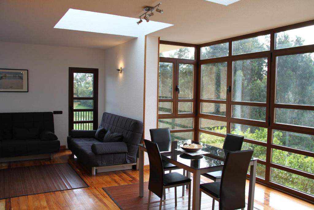 a living room with a table and chairs at Sierra Pulide Apartamentos in Salinas