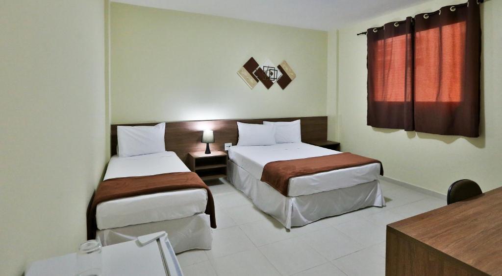 Un pat sau paturi într-o cameră la Hotel Mont Rey
