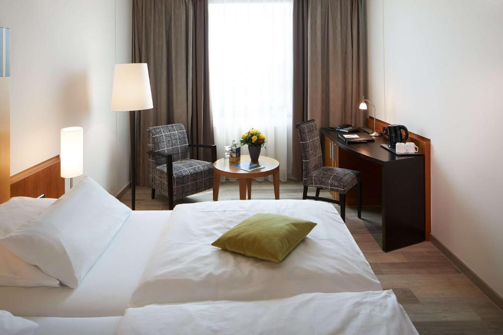 Postel nebo postele na pokoji v ubytování Best Western Plus Arosa Hotel