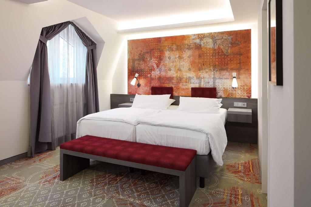 Postel nebo postele na pokoji v ubytování Best Western Plus Arosa Hotel