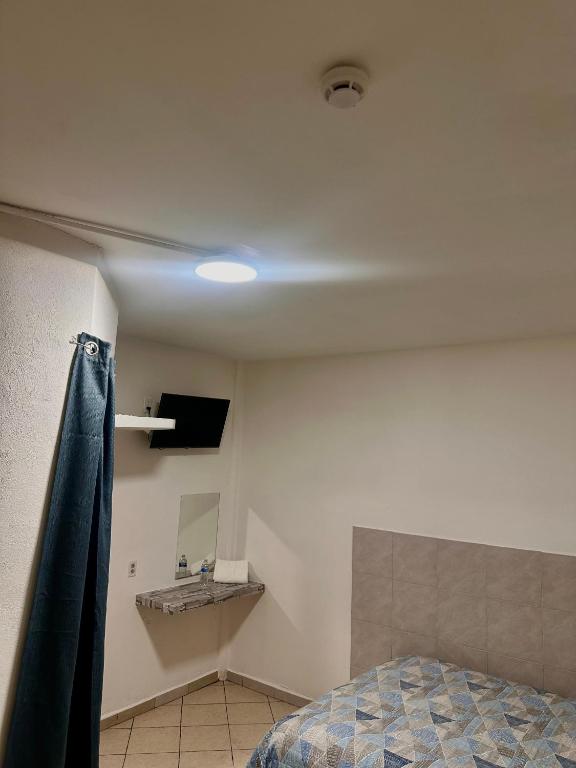a bedroom with a ceiling with a bed and a mirror at Cuartos Lupita descansa como en casa in Cabo San Lucas