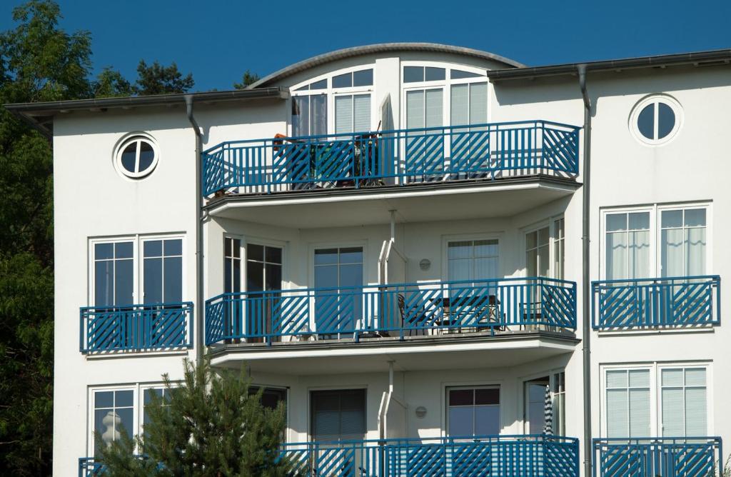 オストゼーバート・ゼリンにあるFerienwohnung "Bellevue" in Sellin auf Rügenの青いバルコニー付きの白い建物
