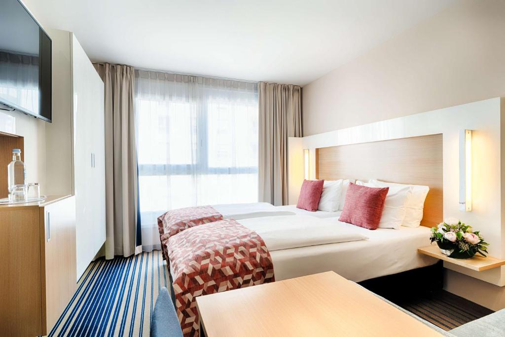 Postel nebo postele na pokoji v ubytování Best Western Plus Welcome Hotel Frankfurt
