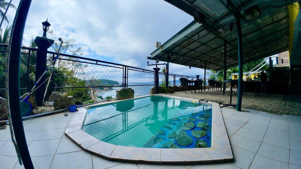 a swimming pool with a view of the water at Dream Hill Condos & Spa in Puerto Galera
