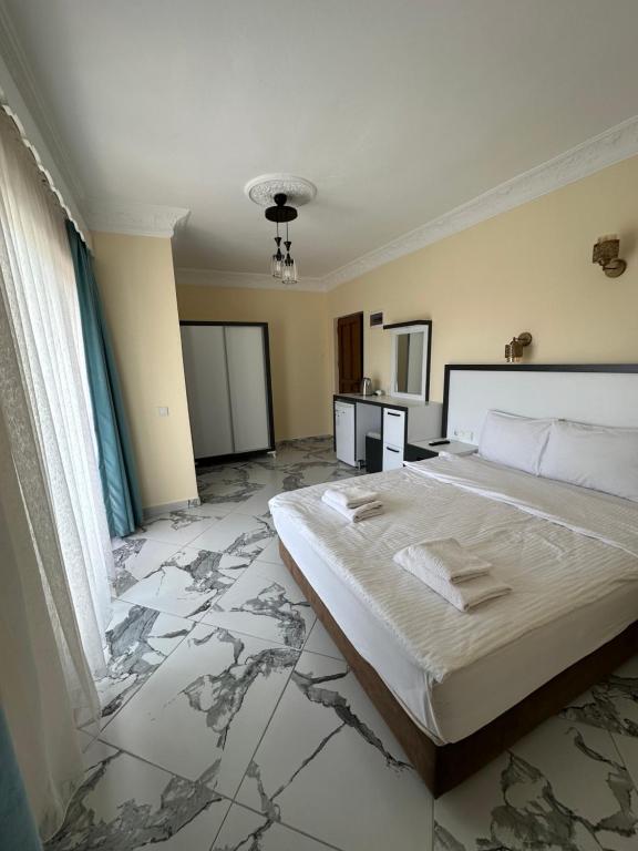 Postel nebo postele na pokoji v ubytování Palm Konak Hotel