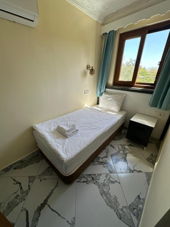 Postel nebo postele na pokoji v ubytování Palm Konak Hotel