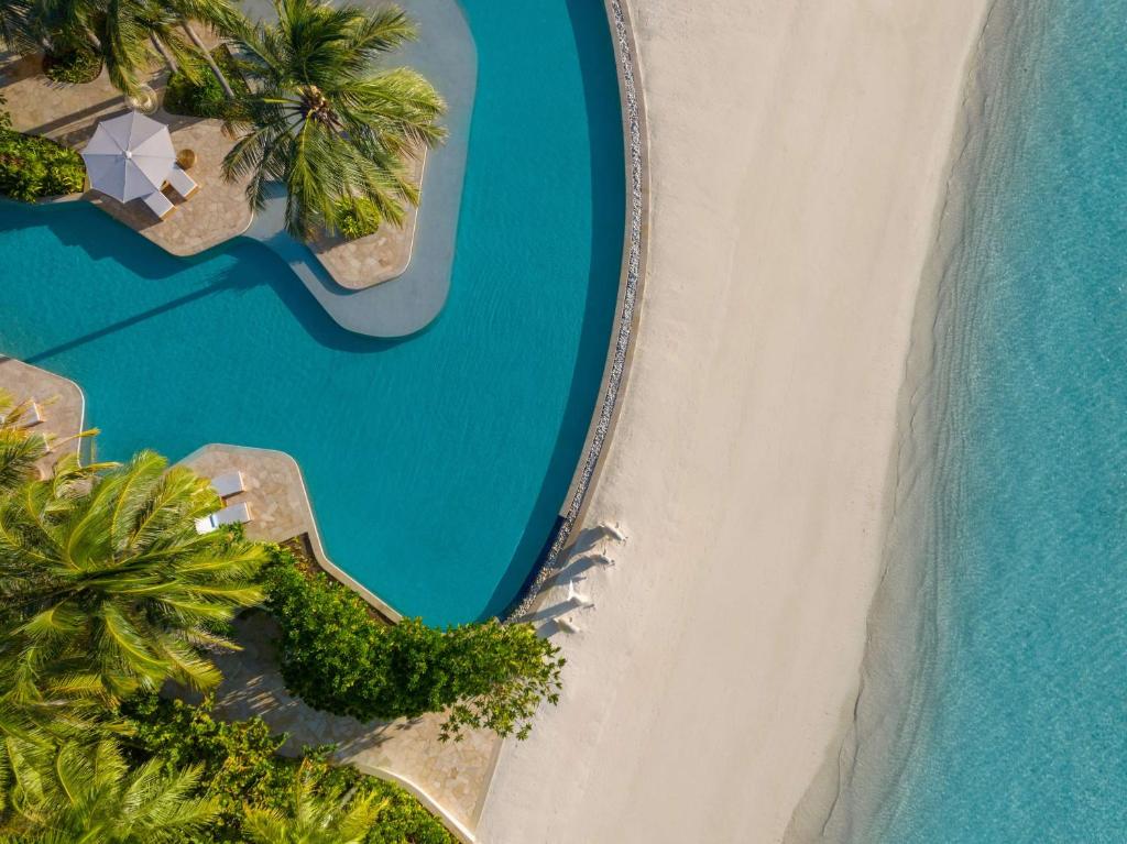 an aerial view of the beach and the ocean at Waldorf Astoria Maldives Ithaafushi in South Male Atoll