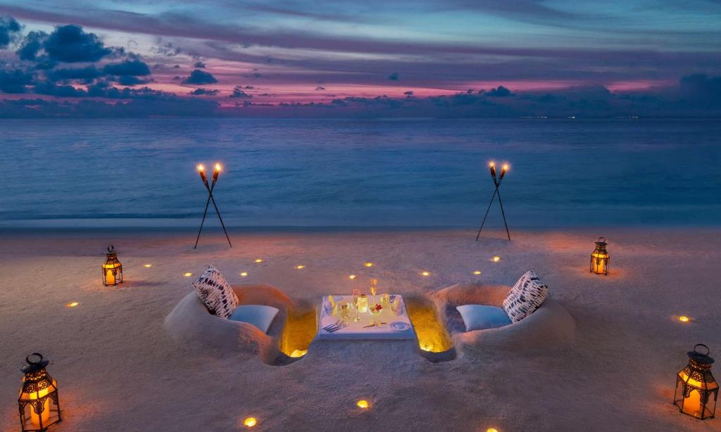 a romantic dinner on the beach at night at Waldorf Astoria Maldives Ithaafushi in South Male Atoll