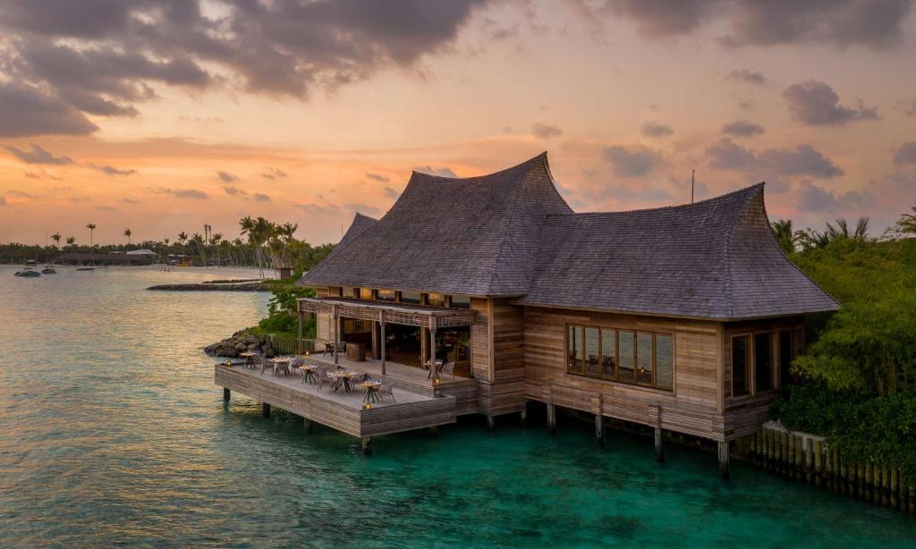 a house on a dock in the water at Waldorf Astoria Maldives Ithaafushi in South Male Atoll