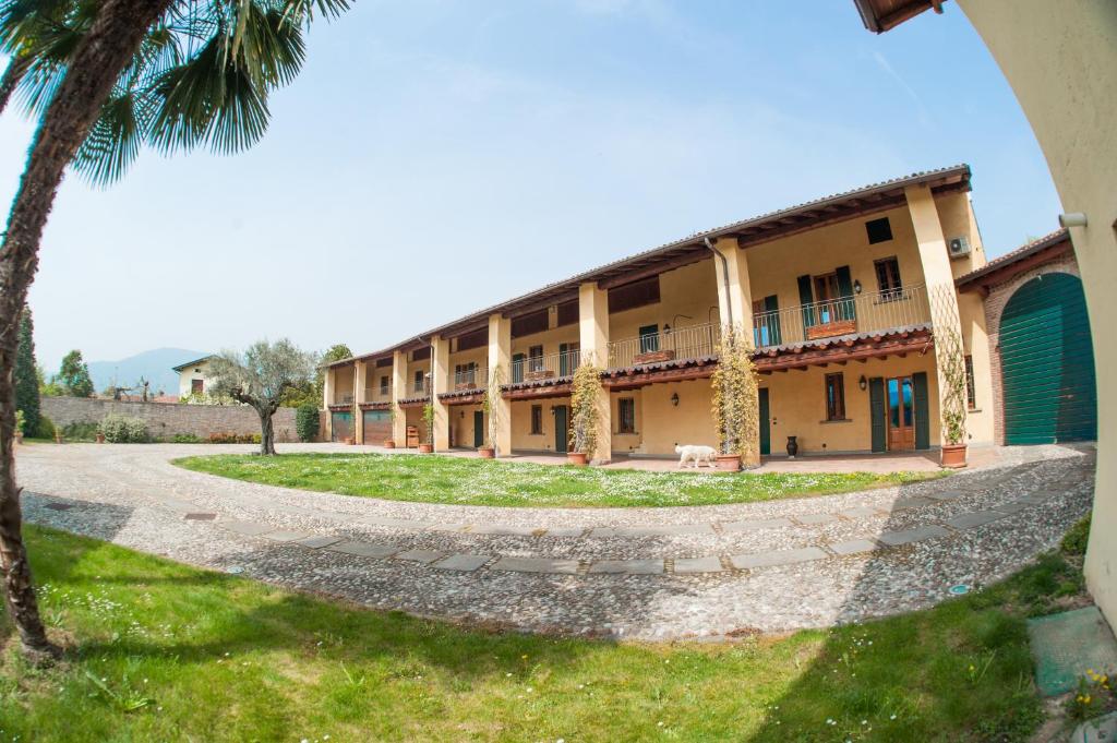 a large building with palm trees in the foreground at Agriturismo Villa Antonella in Iseo