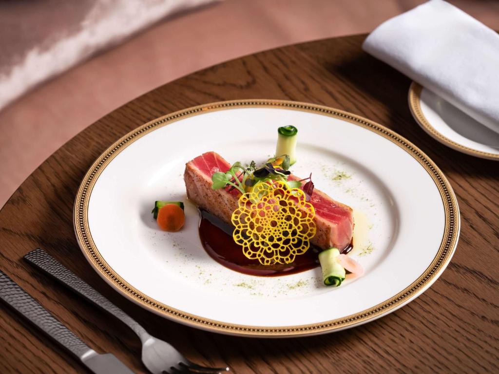 a plate of food with meat on a table at Fairmont Chateau Laurier in Ottawa