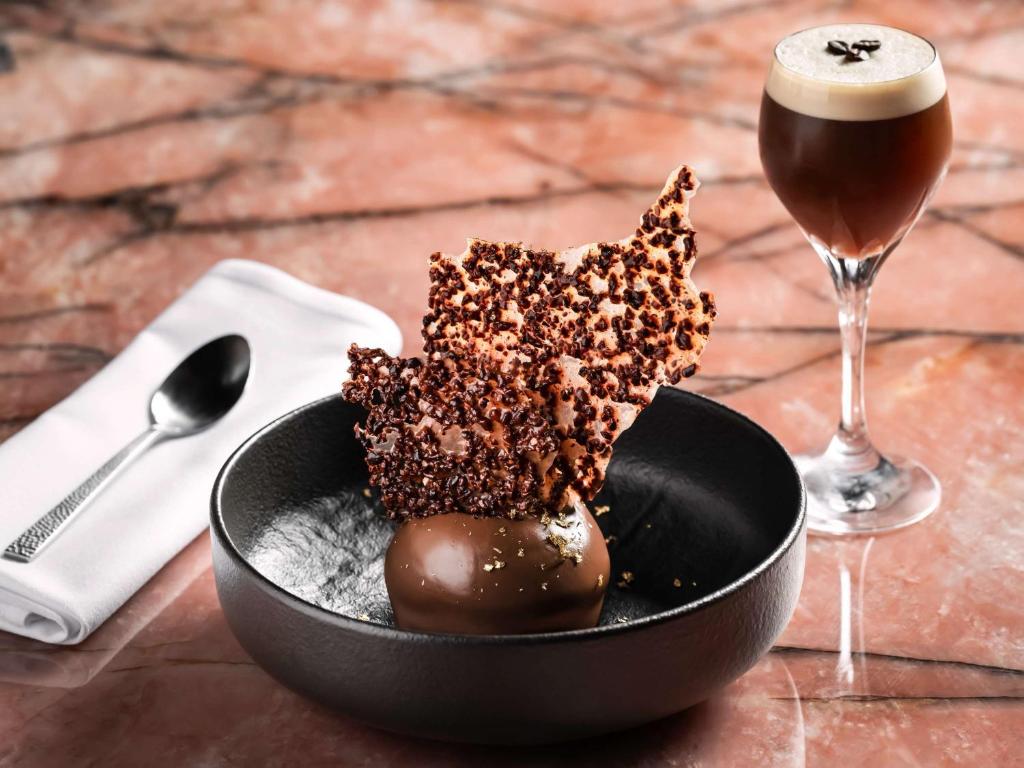 a bowl of chocolate dessert and a glass of beer at Fairmont Chateau Laurier in Ottawa