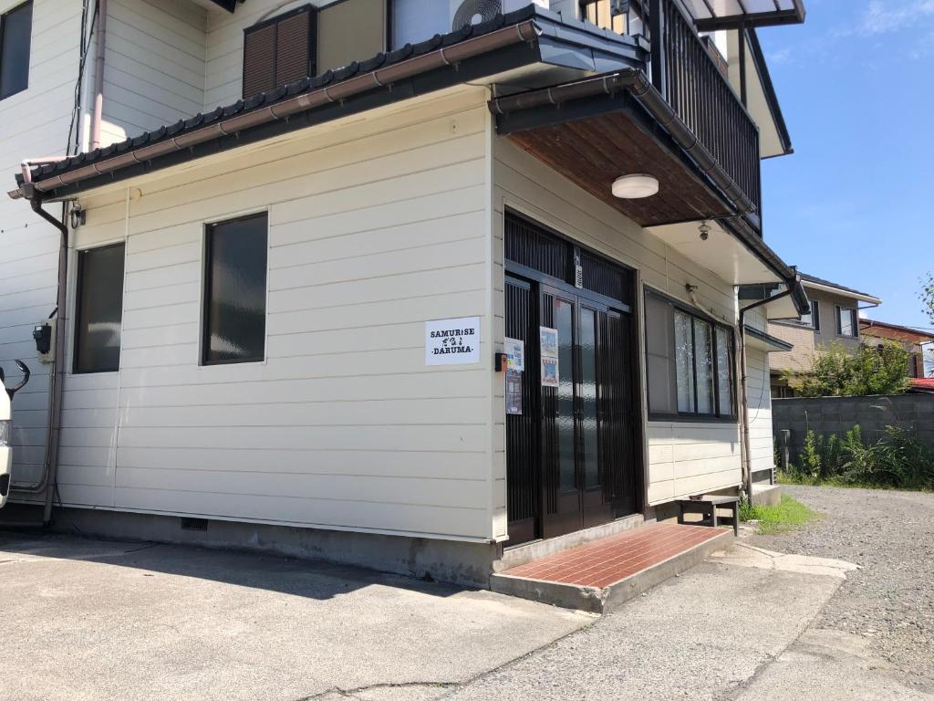 a front door of a house with a sign on it at SAMURISE DARUMA in Fujiyoshida