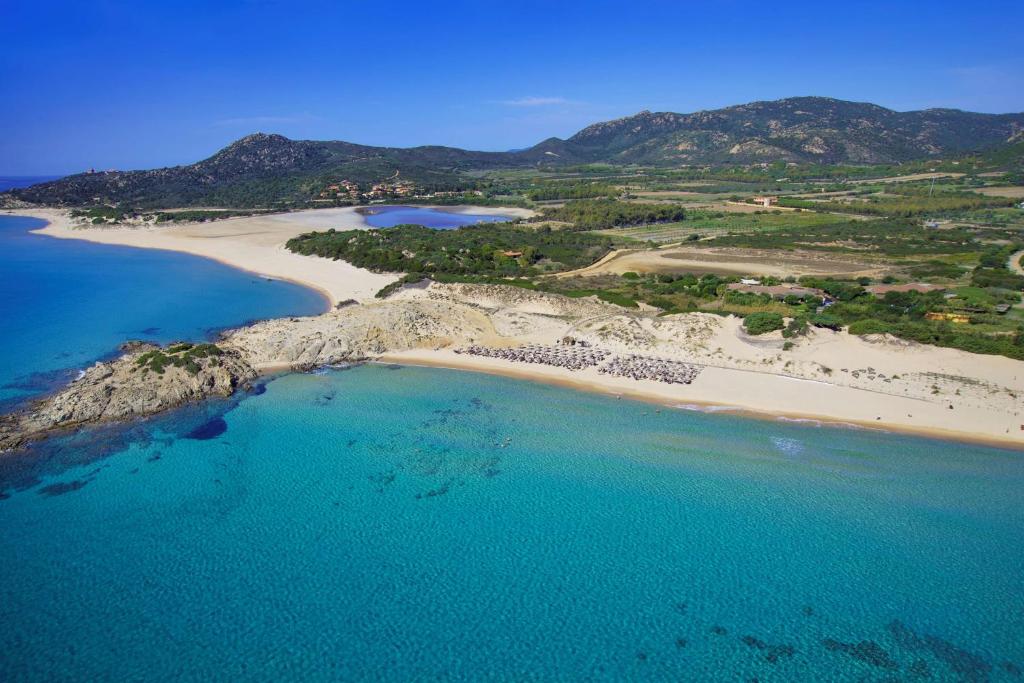 an aerial view of a beach and the ocean at Conrad Chia Laguna Sardinia in Chia