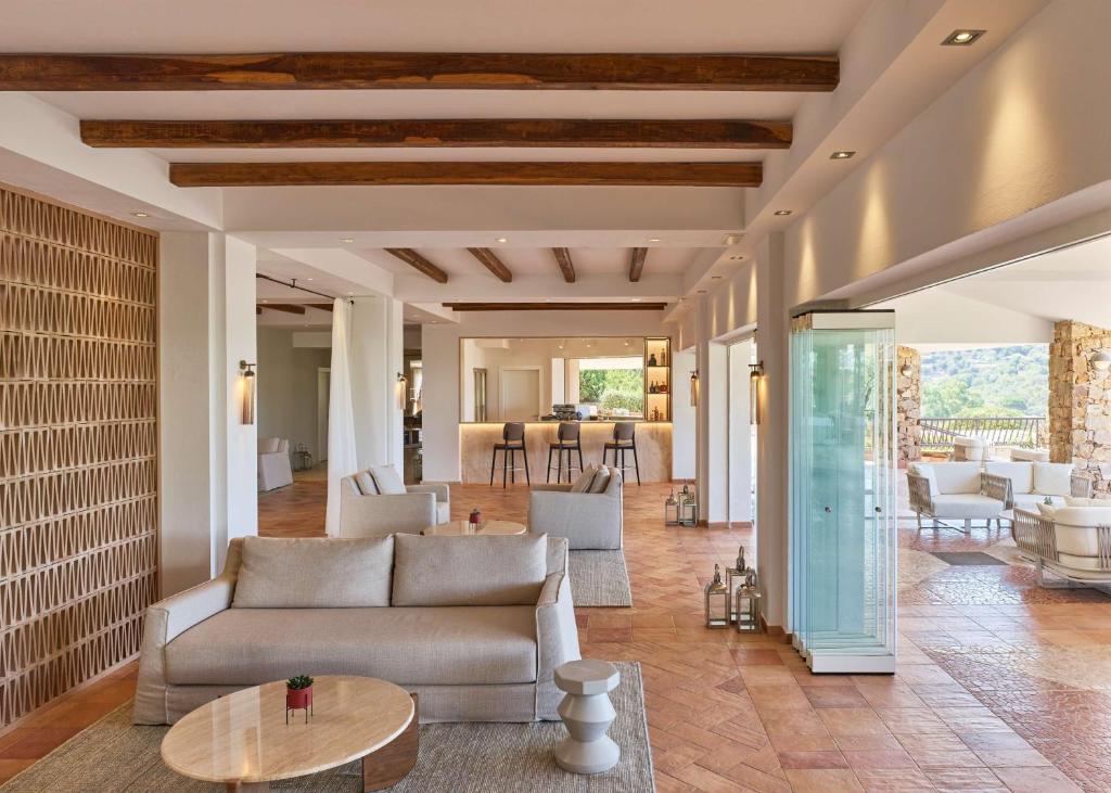 a living room with a couch and a table at Conrad Chia Laguna Sardinia in Chia