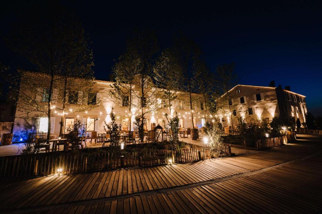 a building lit up at night with christmas lights at Le Hameau Des Pesquiers Ecolodge & Spa, Curio Collection By Hilton in Hyères