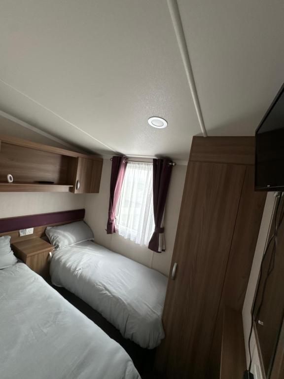 a small room with two beds and a window at Waterfront Kent coast in Rochester