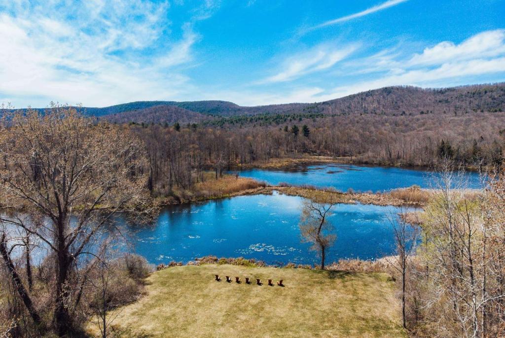 a view of a river with blue water and trees at The Yankee Inn in Lenox