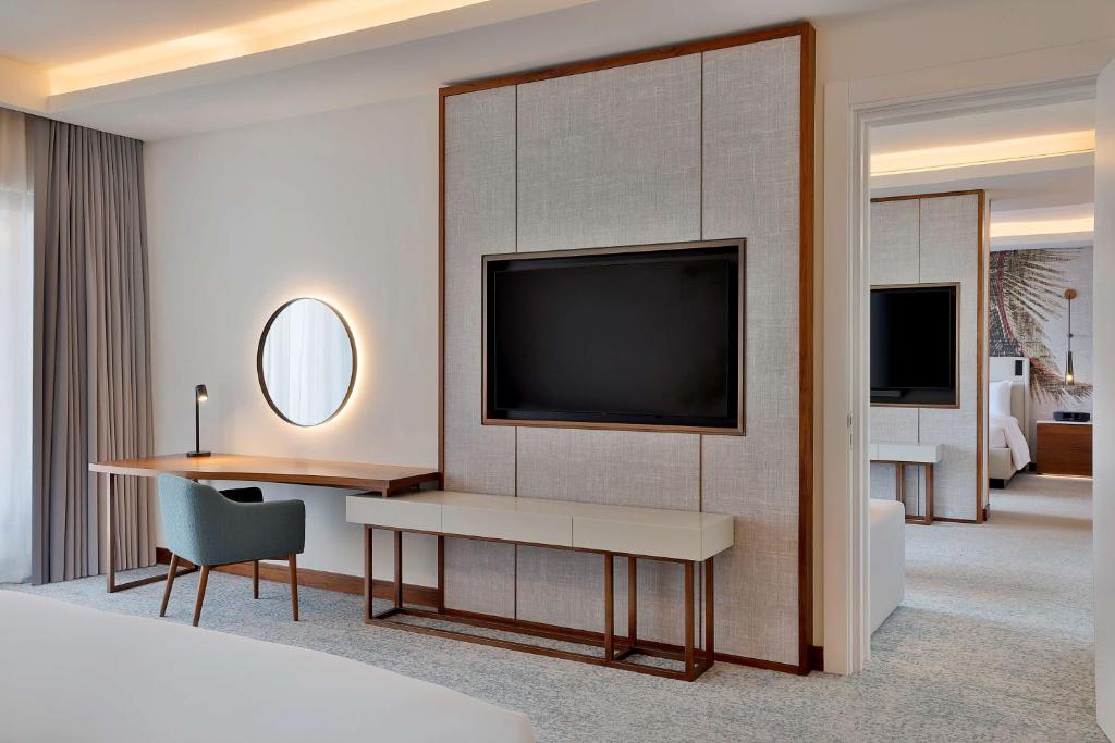 a hotel room with a tv on a wall at Conrad Rabat Arzana in Rabat